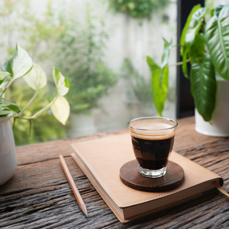 Coffee and notebook by the windowの写真素材