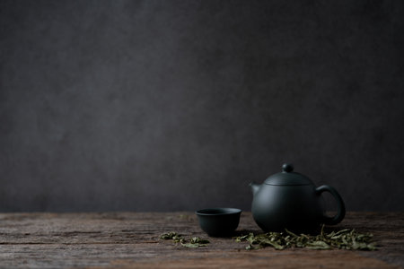 A dried stevia tea set arranged on a rustic wooden table, styled against a dark grunge wall in a moody, atmospheric settingの写真素材