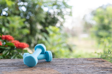 Blue dumbbells on wooden tableの写真素材