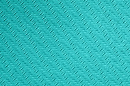 Blue background with diagonal wavy curve macro pattern with rough texture