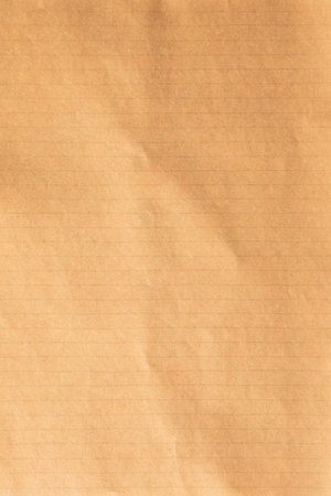 Old brown kraft school paper notebook texture with visible creasesの写真素材