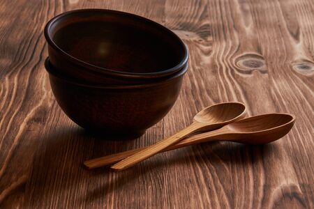 clay plates with wooden spoons on a wooden tableの写真素材
