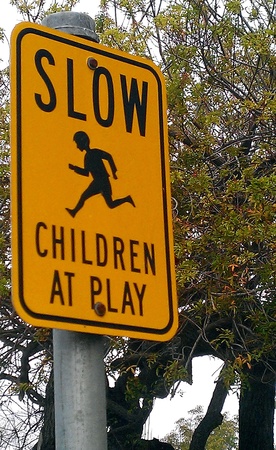 Children Playing Speed Sign の写真素材