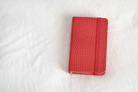 Notepad standing on white groundの写真素材