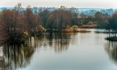 Spring landscape with a lake in the eveningの写真素材
