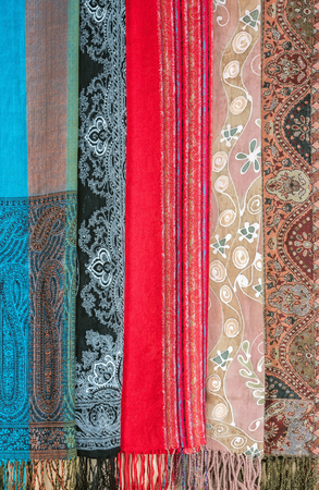 Colorful variety of palantines with ethnic ornament hanging for sale.