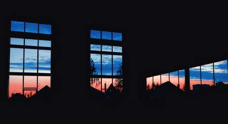 Beautiful view of the night sky from a dark hangar through the huge rectangular windows.の写真素材