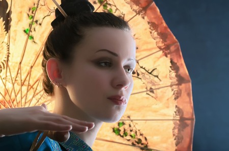Stylized portrait of a young woman with the Chinese yellow paper umbrella on a blue background.の写真素材
