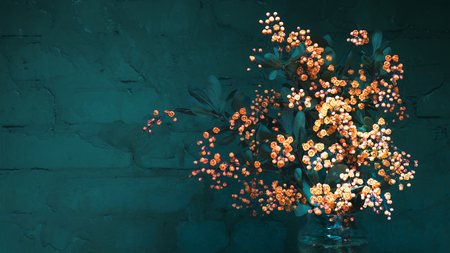 Bouquet of yellow flowers of blossoming barberry in a glass jar against the dark green brick background. Selective focus, toned, space for copying.の写真素材