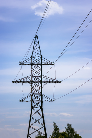 High voltage tower against the blue sky. Industrial background with space for copy. Selective focus.の写真素材