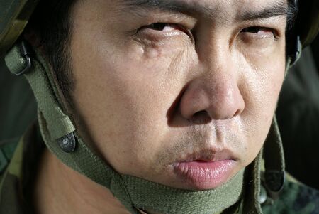 Grim asian soldier with helmetの写真素材