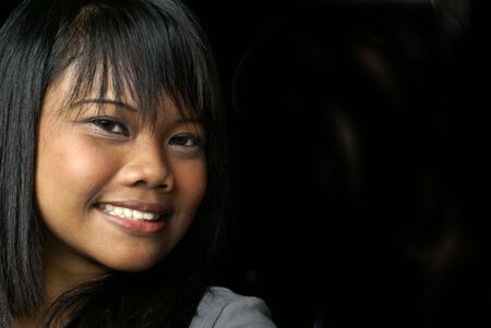 Smiling asian girl on blackの写真素材