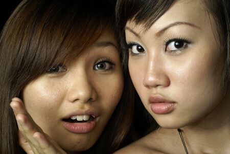 Two surprised asian lady friendsの写真素材
