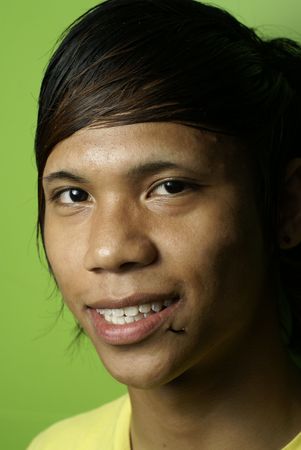 Smiling asian man on greenの写真素材