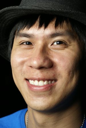 Happy asian chinese man with hatの写真素材