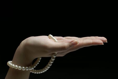Female hand with pearls palm upの写真素材