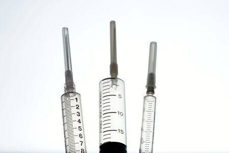 Three medical syringes の写真素材