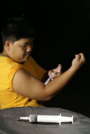 Asian man injecting drugsの写真素材