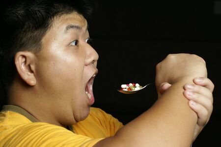 Man eating pills with weird expressionの写真素材