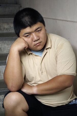 Unhappy man on stepsの写真素材