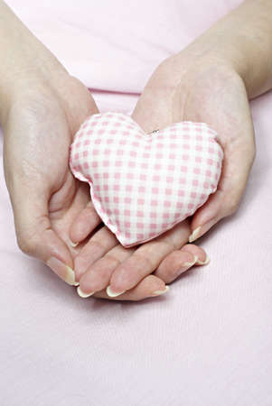 Love shaped cushion in handの写真素材