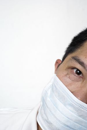 Asian man in medical mask portrait hiding part of his face, copyspaceの写真素材