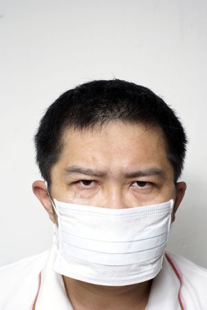 Serious asian man in medical mask portraitの写真素材