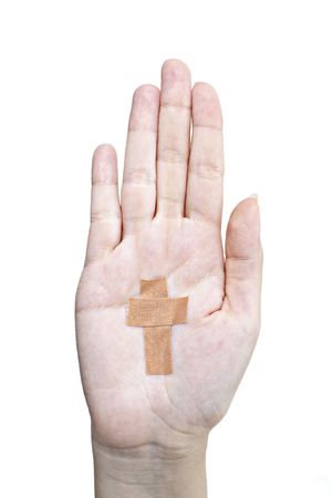 Female hand with plaster cross on white backgroundの写真素材