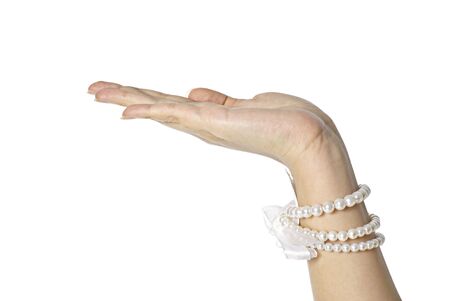 Female hand with pearls with palm up on white background, luxury emphasisの写真素材