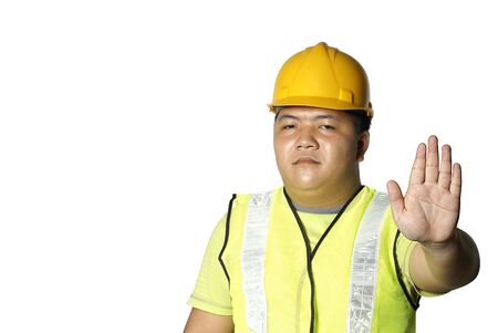 Asian construction worker with stop hand signal on white backgroundの写真素材