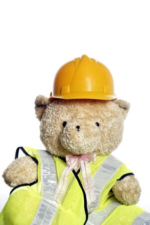 Construction helmet on teddy bear with white background の写真素材