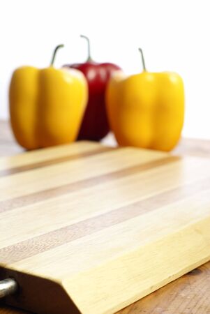 Wooden chopping board and capsicum chilli peppersの写真素材