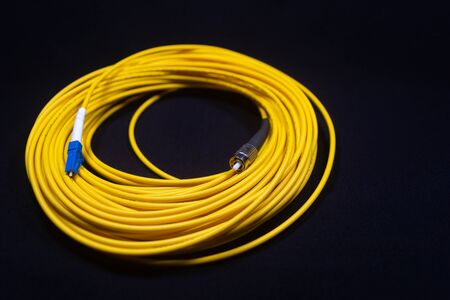 LC FC CONNECTOR YELLOW OFC PATCH CORD LUCENT CONNECTOR AND FERRULE CONNECTOR IN BLACK BACKGROUND...