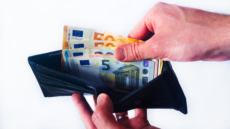 Businessman with black wallet full of euro moneyの写真素材