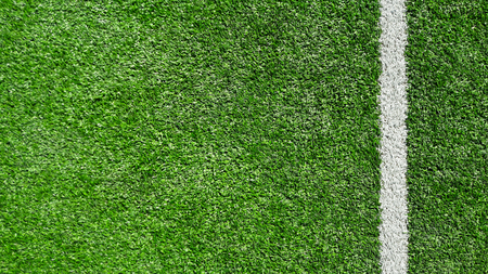 Photo of a green synthetic grass sports field with white line shot from above.の写真素材