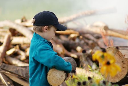 Young village boy bringing hard firewood の写真素材