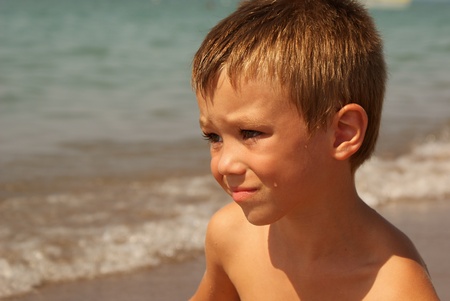 Portrait of young boy with sea on background の写真素材