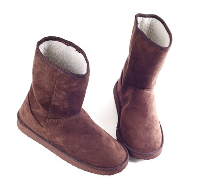 Pair of brown winter boots over pure white backgroundの写真素材