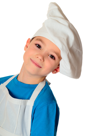 Six years old cook boy isolated on whiteの写真素材