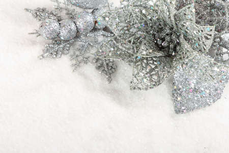 Silver christmas baubles on white snow backgroundの写真素材