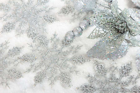 Silver christmas baubles on white snow backgroundの写真素材