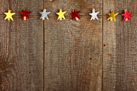 Clothes-peg in shape of star on old wooden backgroundの写真素材