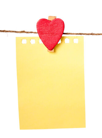 Clothes-peg in shape of heart isolated on white backgroundの写真素材
