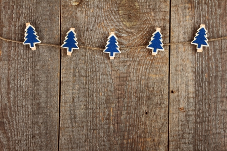 Clothes-peg in shape of Christmas tree on old wooden backgroundの写真素材