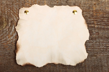 Old crushed paper on brown wooden backgroundの写真素材