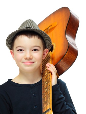 Portrait of eleven years old boy with guitar on white backgroundの写真素材