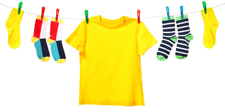 Colorful t-shirt and socks hanging on the clothesline. Image isolated on white backgroundの写真素材