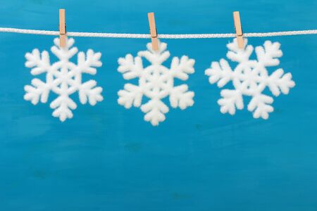 Christmas baubles in shape snowflake on blue wooden backgroundの写真素材