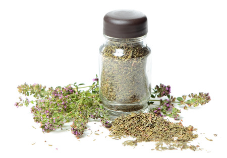 Glass bottle with thyme on white backgroundの写真素材