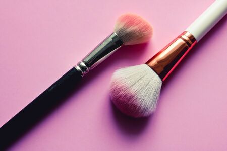 Make up set, soft makeup brushes and maskara on pink background. Fashion colorful concept.の写真素材